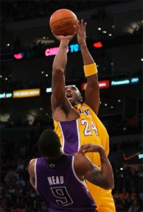 Kobe Bryant scores two over Luther Head.