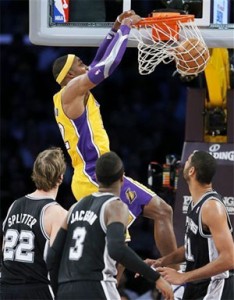 Dwight Howard dunks amongst three Spurs on Tuesday.